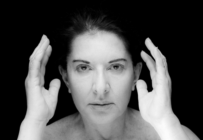 Foto van Marina Abramović met handen rond haar gezicht