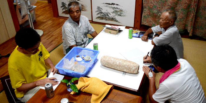 Randall Sasaki (Kyushu National Museum, front left), and Professor Ikeda (Ryukyu University, front right), interviewing members of the local community on Tarama Island, Japan, 2016 (photo: RCE)