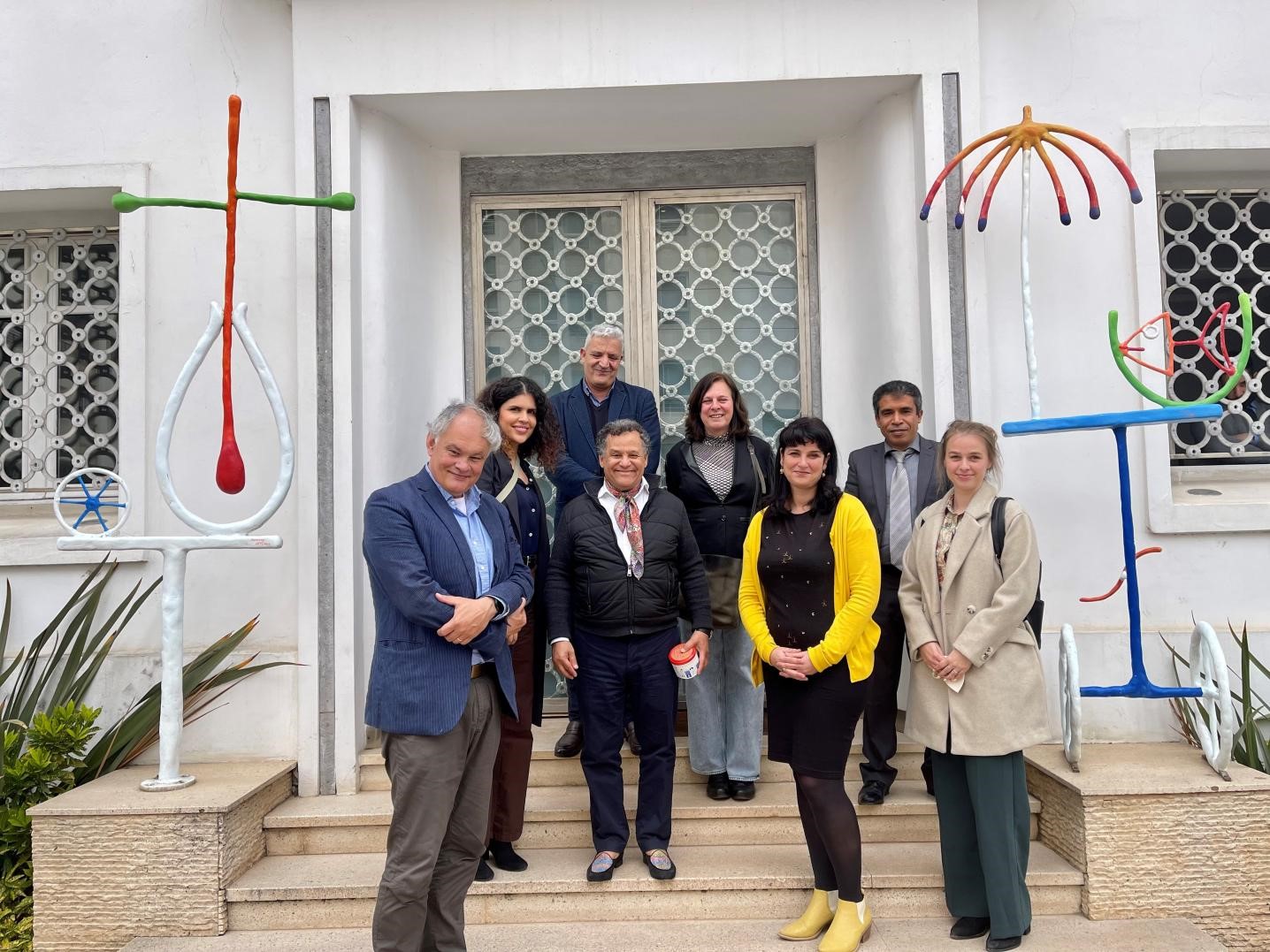Delegation in front of building